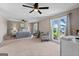 Spacious main bedroom with plush carpet, ceiling fan, sitting area, and serene lake views at 3222 Bay View Dr, Jonesboro, GA 30236