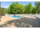 Inviting pool area with ample seating and surrounded by mature trees at 3222 Bay View Dr, Jonesboro, GA 30236