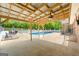 Spacious covered patio with fan, adjacent to a sparkling pool and lounging area at 3222 Bay View Dr, Jonesboro, GA 30236