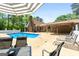 Poolside patio seating area for entertaining with convenient covered access to the house at 3222 Bay View Dr, Jonesboro, GA 30236