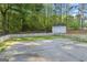 Spacious backyard featuring a concrete patio, storage shed and bordered by a white lattice fence at 643 Rangeley Meadows Ct, Hampton, GA 30228