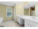 Bathroom with double vanity, a large mirror and a bathtub at 643 Rangeley Meadows Ct, Hampton, GA 30228