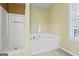 Bathroom features a large tub and a standing shower at 643 Rangeley Meadows Ct, Hampton, GA 30228