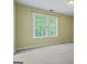 Bright bedroom features a large window offering ample natural light, enhancing the cozy carpeted space at 643 Rangeley Meadows Ct, Hampton, GA 30228