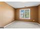 A standard bedroom featuring neutral walls, carpeted floors and a window at 643 Rangeley Meadows Ct, Hampton, GA 30228
