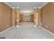 Carpeted dining room with decorative columns, a chandelier, and a view into another room at 643 Rangeley Meadows Ct, Hampton, GA 30228