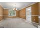 Dining room with a chandelier, neutral carpet, and a view into the adjacent kitchen at 643 Rangeley Meadows Ct, Hampton, GA 30228