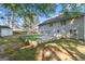 Back exterior of home features a large yard, back patio, shed, and lots of natural shade at 643 Rangeley Meadows Ct, Hampton, GA 30228