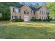 Charming brick two-story home with black shutters, white door, and well-manicured lawn at 643 Rangeley Meadows Ct, Hampton, GA 30228