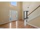 Bright foyer featuring hardwood floors, a staircase, and a view of the front door with sidelights at 643 Rangeley Meadows Ct, Hampton, GA 30228
