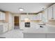 Bright kitchen with white cabinets, tile floors, and stainless steel range and hood at 643 Rangeley Meadows Ct, Hampton, GA 30228