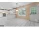Bright kitchen featuring white cabinets, tile flooring and stainless steel appliances at 643 Rangeley Meadows Ct, Hampton, GA 30228