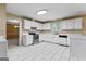 Spacious kitchen with white cabinets, tile backsplash, stainless steel appliances, and tile flooring at 643 Rangeley Meadows Ct, Hampton, GA 30228
