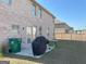Spacious backyard with brick home, cement patio, grill, and fenced perimeter at 169 Cabin Way, Hampton, GA 30228