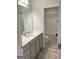 Well-lit bathroom features a modern vanity with a white countertop and sleek fixtures at 169 Cabin Way, Hampton, GA 30228