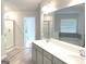 Bathroom featuring double sinks, shower, tub, and wood-look flooring and clean contemporary lines at 169 Cabin Way, Hampton, GA 30228