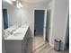 Bathroom showcasing double sinks, wood-look flooring, and clean, bright lines at 169 Cabin Way, Hampton, GA 30228