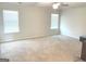 Spacious bedroom featuring plush carpeting, a ceiling fan, and natural light from the windows at 169 Cabin Way, Hampton, GA 30228