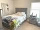 Comfortable bedroom features soft carpeting, a cozy bed, and ample natural light from the window at 169 Cabin Way, Hampton, GA 30228