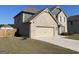 Two-story brick home with a two car garage and a concrete driveway at 169 Cabin Way, Hampton, GA 30228