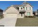 Beautiful two-story brick home with a two car garage, manicured lawn, and neutral color palette at 169 Cabin Way, Hampton, GA 30228