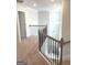 Upstairs hallway with wood and metal railings at 169 Cabin Way, Hampton, GA 30228