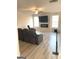 Open living room with wood grain vinyl flooring, a fireplace and large windows at 169 Cabin Way, Hampton, GA 30228