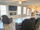 Open living room with wood grain vinyl flooring, a fireplace, three recliners and lots of natural light at 169 Cabin Way, Hampton, GA 30228