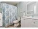 Bathroom includes a vanity with sink, toilet, and tub with patterned curtain at 90 Harlin Ct, Covington, GA 30014