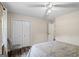 Bedroom offers ceiling fan, closet, window with curtains and a comfortable bed at 90 Harlin Ct, Covington, GA 30014