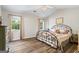 Cozy bedroom with a vaulted ceiling, a metal frame bed, and two windows for natural light at 90 Harlin Ct, Covington, GA 30014