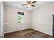 This bedroom features wood floors, a ceiling fan, and neutral paint at 90 Harlin Ct, Covington, GA 30014