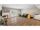 Spacious bonus room with wood floors, French doors to the outside and lots of storage containers at 90 Harlin Ct, Covington, GA 30014