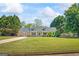 Charming single story home with dormer windows and a large front yard with mature landscaping at 90 Harlin Ct, Covington, GA 30014