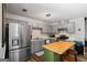 Modern kitchen featuring gray cabinets, a stainless steel refrigerator, and butcher block island at 90 Harlin Ct, Covington, GA 30014