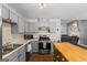 Well-lit kitchen featuring gray cabinets, modern appliances, and a butcher block island at 90 Harlin Ct, Covington, GA 30014