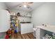 Functional laundry room with washer, dryer, storage shelves, and counter space at 90 Harlin Ct, Covington, GA 30014