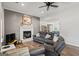 Bright living room with fireplace, grey plank wall, and modern ceiling fan at 90 Harlin Ct, Covington, GA 30014