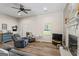 Spacious living room with ceiling fan, plank flooring and plenty of sunlight at 90 Harlin Ct, Covington, GA 30014