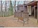 Backyard view of the home with bare spot, wood bench, fence, and covered area at 26 Cobblestone Crk, Peachtree City, GA 30269