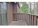 A wooden balcony overlooks lush trees, adding to the outdoor appeal of this home at 26 Cobblestone Crk, Peachtree City, GA 30269