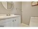 Cozy half bathroom with a white vanity and neutral paint that is perfect for guests at 26 Cobblestone Crk, Peachtree City, GA 30269