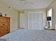 Well-lit bedroom features a ceiling fan and a closet with louvered doors at 26 Cobblestone Crk, Peachtree City, GA 30269