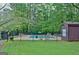 Fenced community pool area with ample seating and mature trees, offering a recreational amenity at 26 Cobblestone Crk, Peachtree City, GA 30269