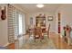 Bright dining room featuring hardwood floors, rug, and sliding glass doors for natural light at 26 Cobblestone Crk, Peachtree City, GA 30269