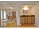 View of a dining area, living room, and wet bar space that features hardwood floors at 26 Cobblestone Crk, Peachtree City, GA 30269