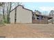 Exterior view of the home with bare yard, wood deck, and a covered patio at 26 Cobblestone Crk, Peachtree City, GA 30269