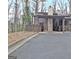 View of the home's exterior and driveway, with a carport, and landscaping at 26 Cobblestone Crk, Peachtree City, GA 30269