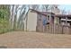 Exterior view of a two story home, showing wood deck, and bare yard at 26 Cobblestone Crk, Peachtree City, GA 30269