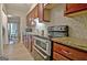 Kitchen with modern appliances and granite countertops, plus a view to the dining area at 26 Cobblestone Crk, Peachtree City, GA 30269